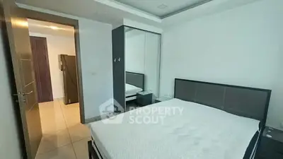 Spacious modern bedroom with sleek design and ample natural light.
