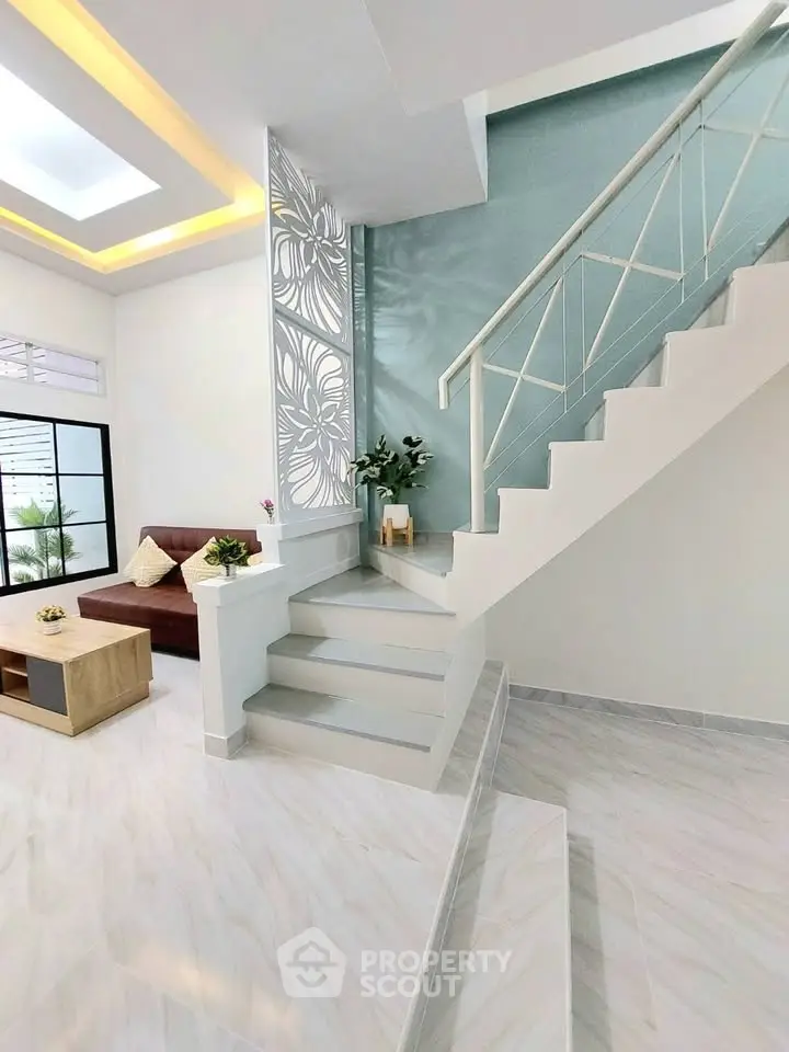 Modern living room with stylish staircase and elegant decor