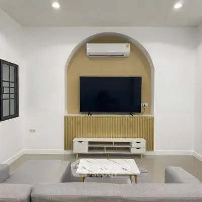 Modern living room with stylish TV setup and air conditioning