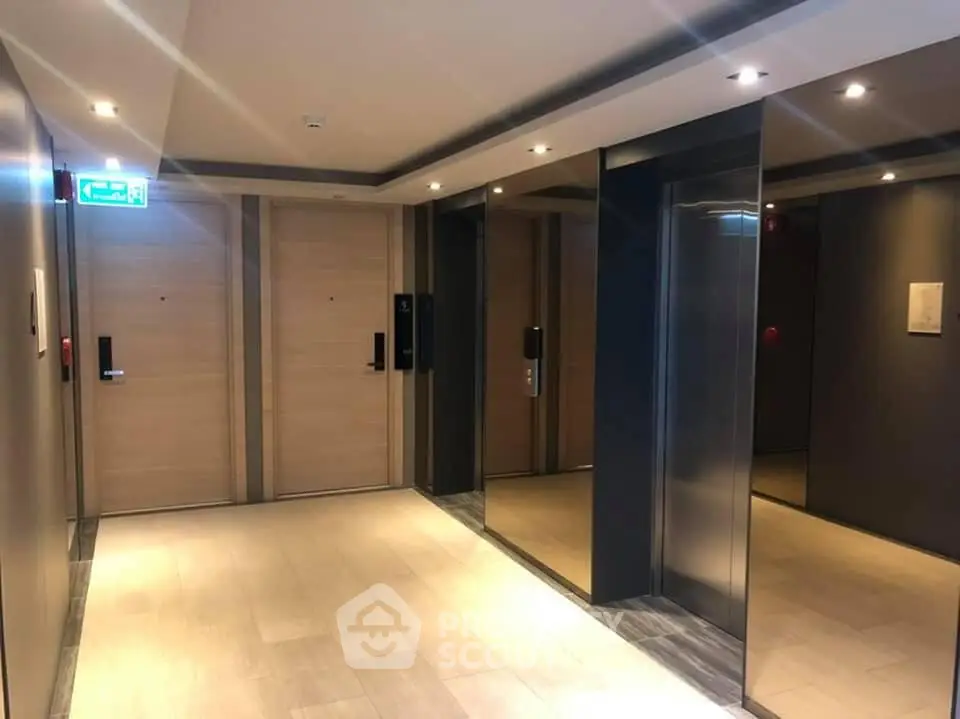 Modern elevator lobby with sleek design and ambient lighting