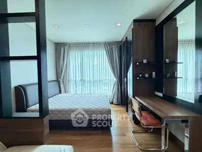 Spacious modern bedroom with elegant wooden furnishings and large windows for natural light.