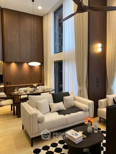 Luxurious modern living room with high ceilings, elegant decor, and a cozy dining area, perfect for sophisticated living.