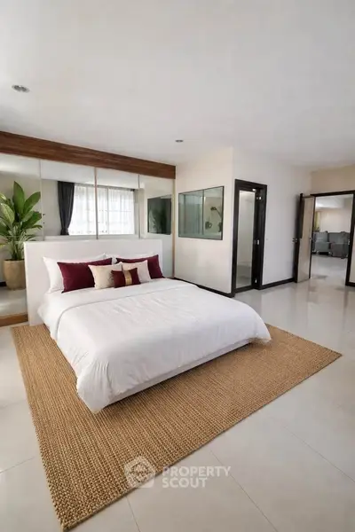 Spacious modern bedroom with elegant decor and natural light