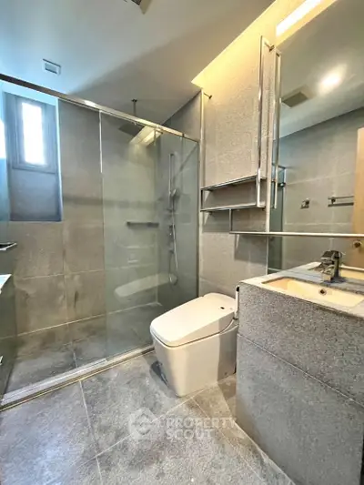 Modern bathroom with sleek design, glass shower, and contemporary fixtures.