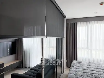 Modern bedroom with sleek design, featuring large windows and stylish furnishings.
