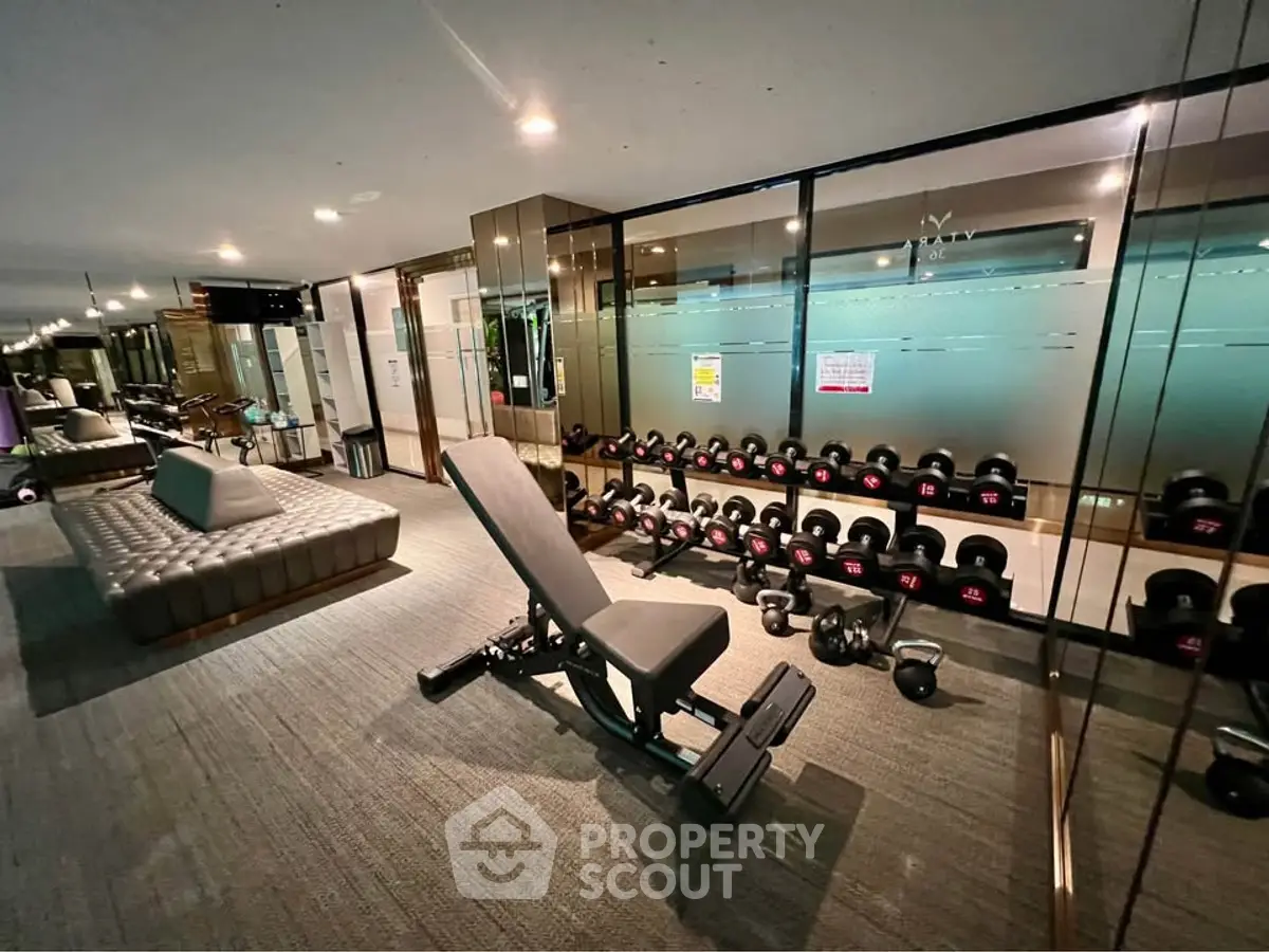 Modern gym with sleek design and state-of-the-art equipment in luxury building.