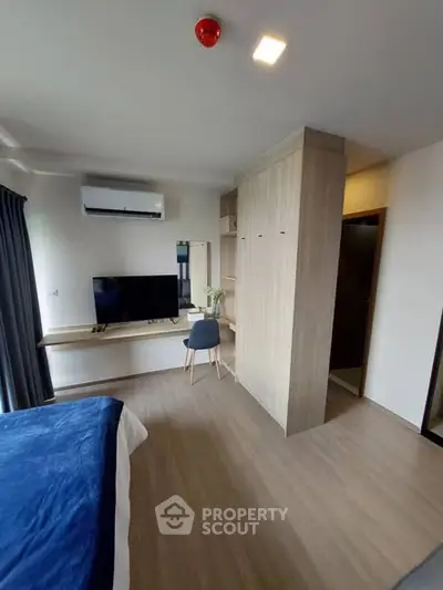 Modern bedroom with built-in wardrobe and sleek TV setup