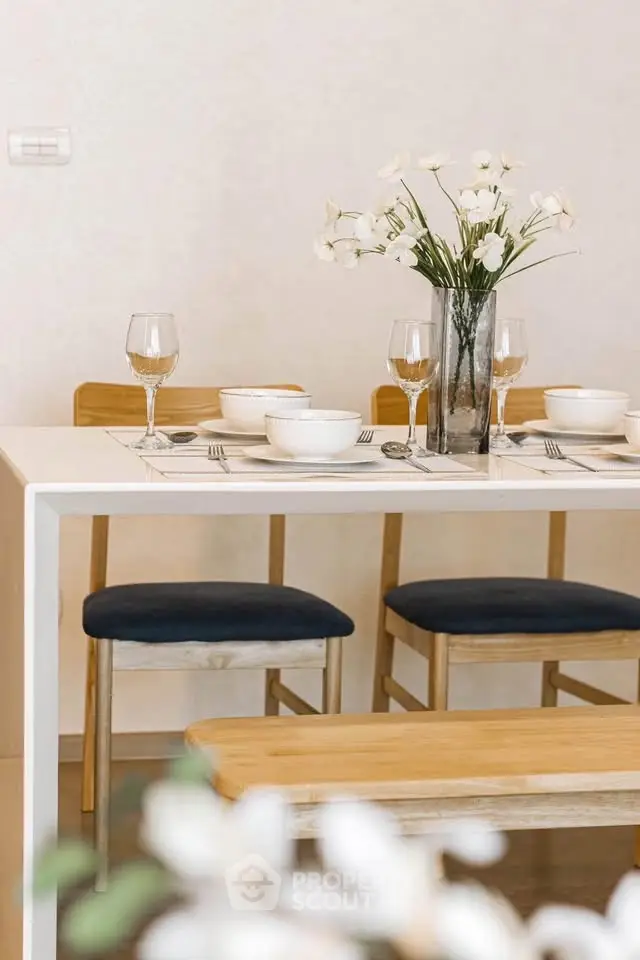 Elegant dining area with modern table setting and floral centerpiece