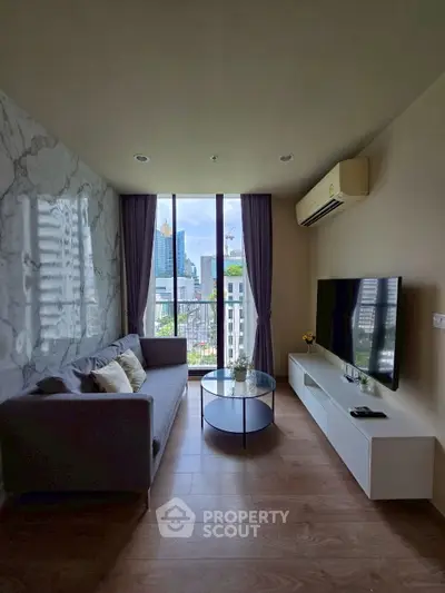 Modern living room with city view, stylish sofa, and large TV setup.