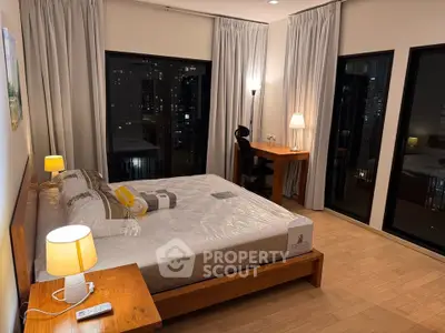 Luxurious bedroom with city view, featuring elegant lighting and modern furnishings for a cozy ambiance.