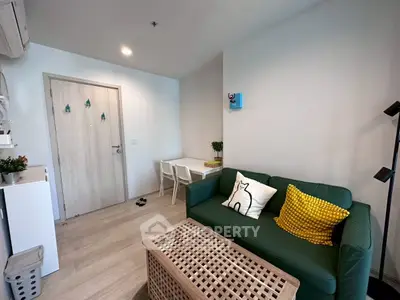 Cozy living room with green sofa and modern decor in a stylish apartment.