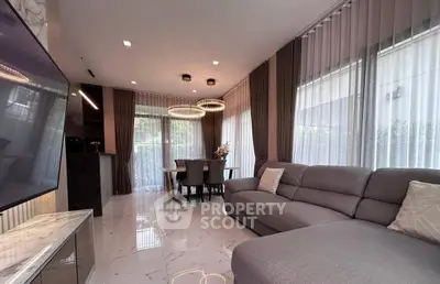 Luxurious modern living room with elegant dining area and stylish lighting.