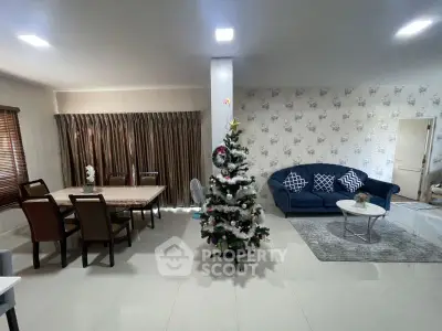 Spacious living room with elegant dining area and festive Christmas tree