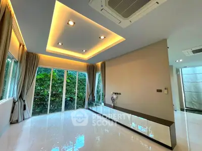 Spacious modern living room with large windows and elegant lighting