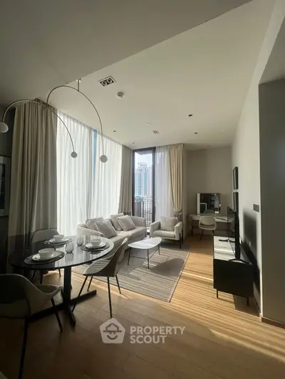 Modern living room with elegant decor and city view, featuring stylish furniture and ample natural light.