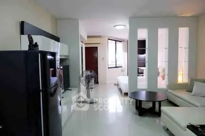 Modern open-plan living room with sleek furniture and bright ambiance