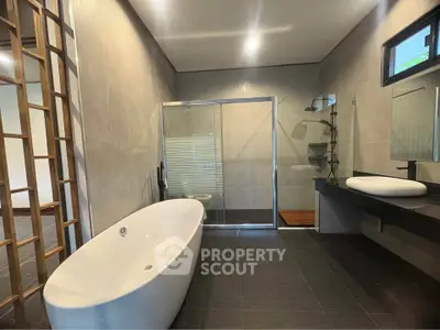 Luxurious modern bathroom with freestanding bathtub and glass shower enclosure