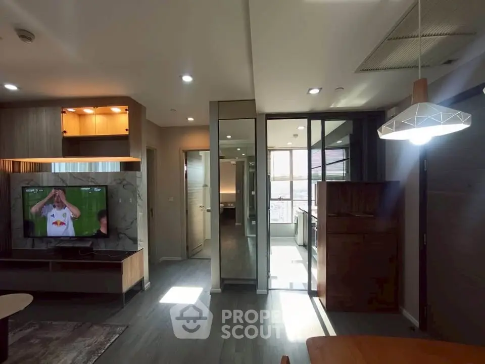 Modern living room with open layout and stylish lighting in a contemporary apartment.
