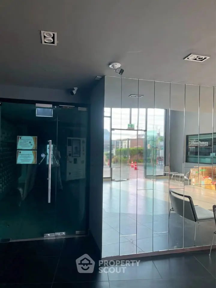 Modern building entrance with glass doors and sleek interior design