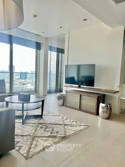 Modern living room with large TV and city view