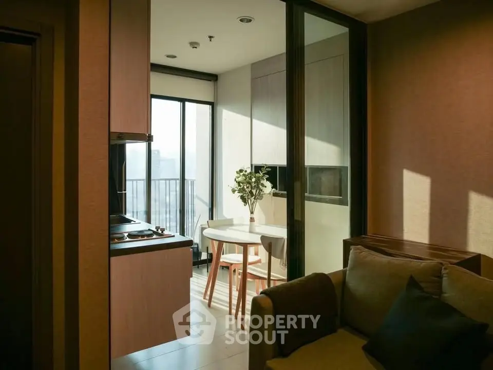 Modern apartment interior with cozy living area and dining space near balcony.