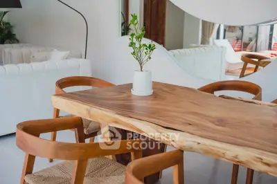 Stylish modern dining area with wooden table and elegant chairs in a bright, open living space.