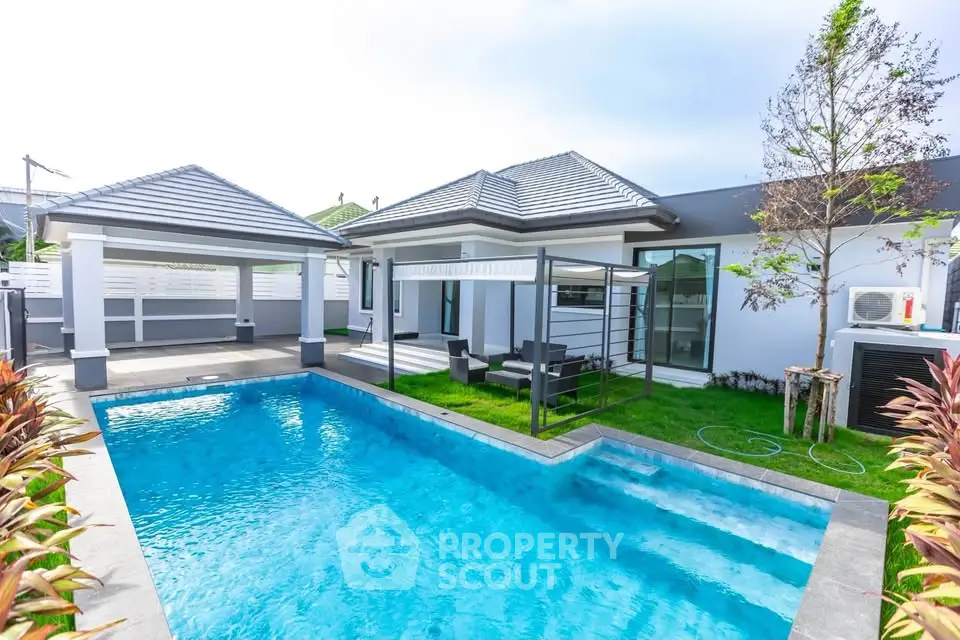 Luxurious modern villa with private pool and lush garden, perfect for relaxation and entertainment.