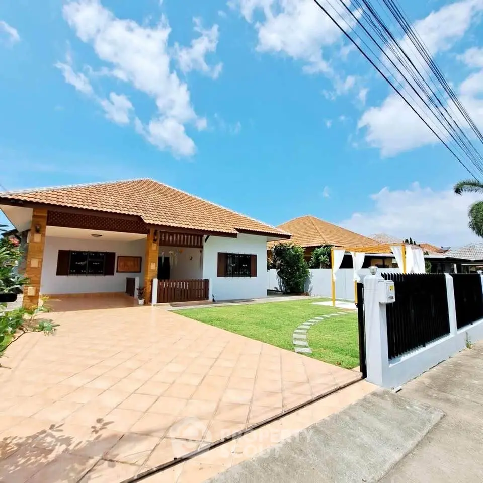 Charming single-story home with tiled roof and spacious driveway in sunny neighborhood.