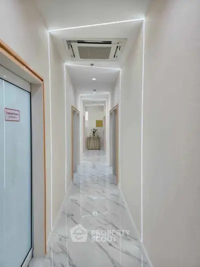 Sleek modern hallway with marble flooring and ambient lighting