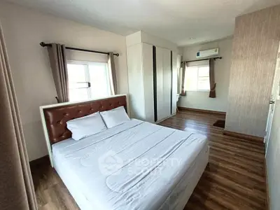 Spacious bedroom with modern design and ample natural light