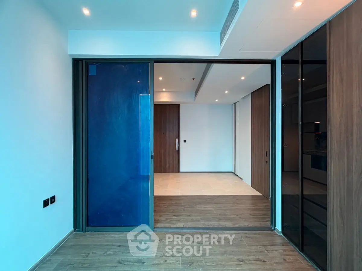 Modern interior with sliding glass doors and wooden flooring in a spacious room