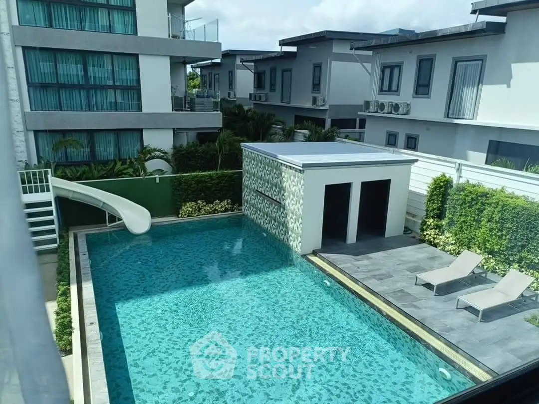 Luxurious residential complex with a stunning outdoor pool and modern architecture.