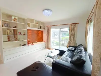 Spacious living room with modern decor and large window view