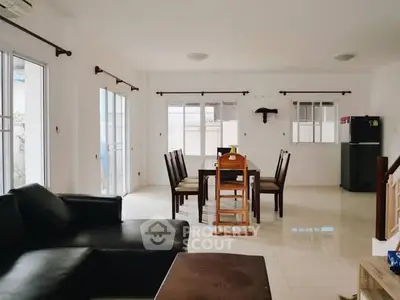 Spacious open-plan living and dining area with modern furniture and natural light.