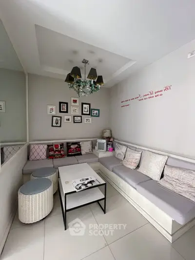 Cozy living room with modern decor, stylish lighting, and comfortable seating area.