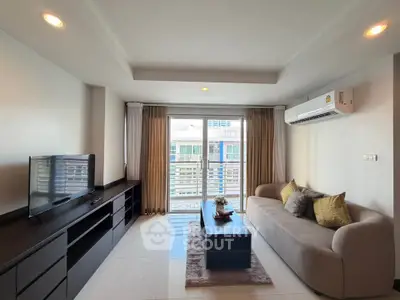Modern living room with sleek furniture and large window offering city view