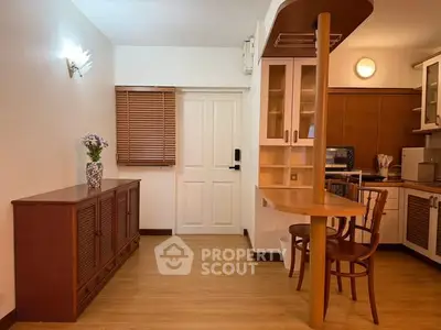 Charming living area with wooden accents and cozy dining space in modern apartment.