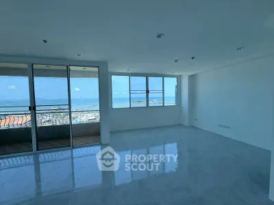 Spacious living room with ocean view and large windows in modern apartment