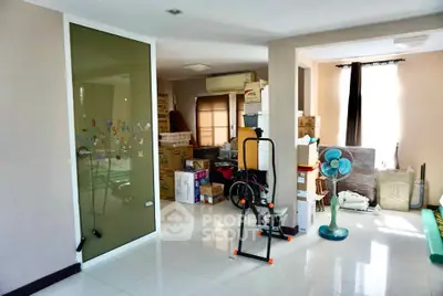 Spacious room with exercise equipment and boxes, ideal for storage or home gym setup.