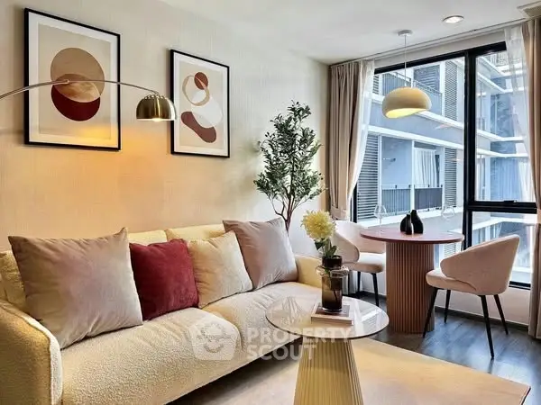 Stylish modern living room with elegant decor and large window view.