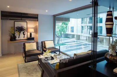 Stylish modern living room with large window offering a view of the building exterior.