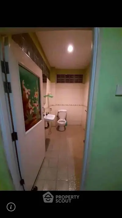 Cozy bathroom with unique wall art and modern fixtures in a charming home.