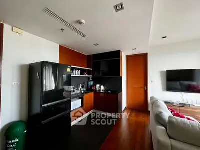 Modern apartment interior with sleek kitchen and cozy living area.