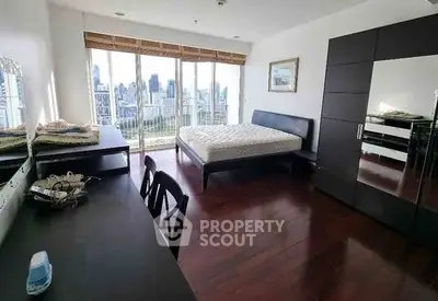 Spacious bedroom with city view and modern furnishings