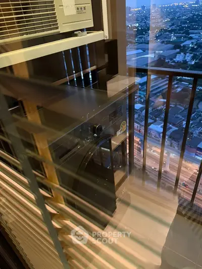 Modern apartment balcony with city view and washing machine setup.