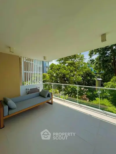 Spacious balcony with lush garden view in modern apartment