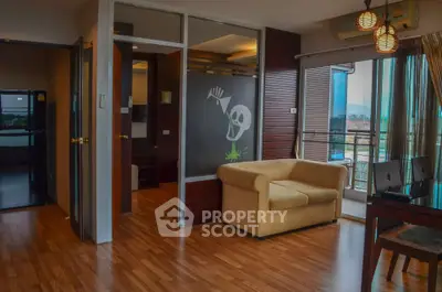 Modern living room with wooden flooring, cozy sofa, and balcony view.