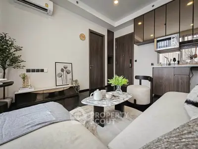 Modern living room with cozy seating and stylish decor in a contemporary apartment.