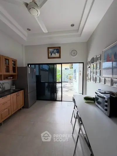 Spacious kitchen with modern appliances and outdoor view, perfect for culinary enthusiasts.