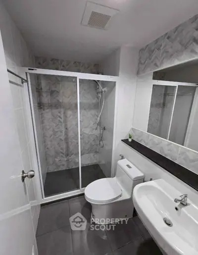 Modern bathroom with glass shower and sleek fixtures